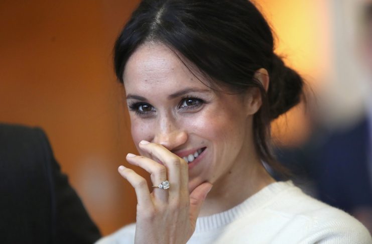 The fiancee of Britain’s Prince Harry, Meghan Markle, reacts during a visit to a science park called Catalyst Inc., in Belfast