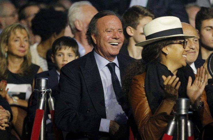Honorary degree recipient recording artist Julio Iglesias smiles from the audience during Berklee College of Music’s Commencement Concert in Boston