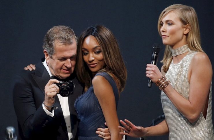 Peruvian photographer Mario Testino, British model Jourdan Dunn and U.S. model Karlie Kloss conduct an auction during the amfAR’s Cinema Against AIDS 2015 event during the 68th Cannes Film Festival in Antibes, near Cannes