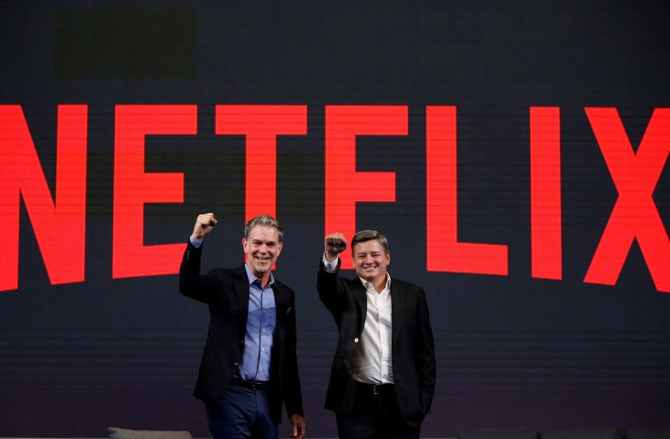 Reed Hastings, co-founder and CEO of Netflix, and Ted Sarandos, Netflix chief content officer, pose for photographs during a news conference in Seoul