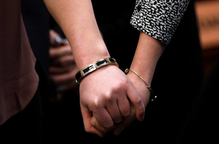 Victims and former gymnasts Maddie and Kara Johnson hold hands as they speak at the sentencing hearing for Larry Nassar, a former team USA Gymnastics doctor who pleaded guilty in November 2017 to sexual assault charges, in Lansing