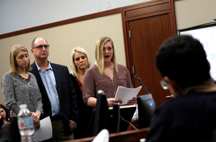 Victims and former gymnasts Maddie and Kara Johnson speak alongside their parents Brad and Kelly Johnson at the sentencing hearing for Larry Nassar, in Lansing