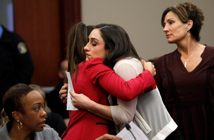 Victim and former gymnast Aly Raisman embraces former USA teammate Jordyn Wieber at the sentencing hearing for Larry Nassar, a former team USA Gymnastics doctor who pleaded guilty in November 2017 to sexual assault charges, in Lansing