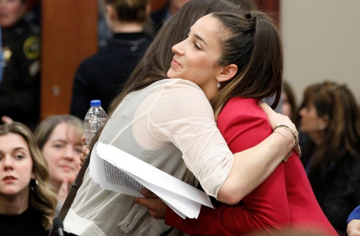 Victim and former gymnast Aly Raisman embraces former USA teammate Jordyn Wieber at the sentencing hearing for Larry Nassar, a former team USA Gymnastics doctor who pleaded guilty in November 2017 to sexual assault charges, in Lansing