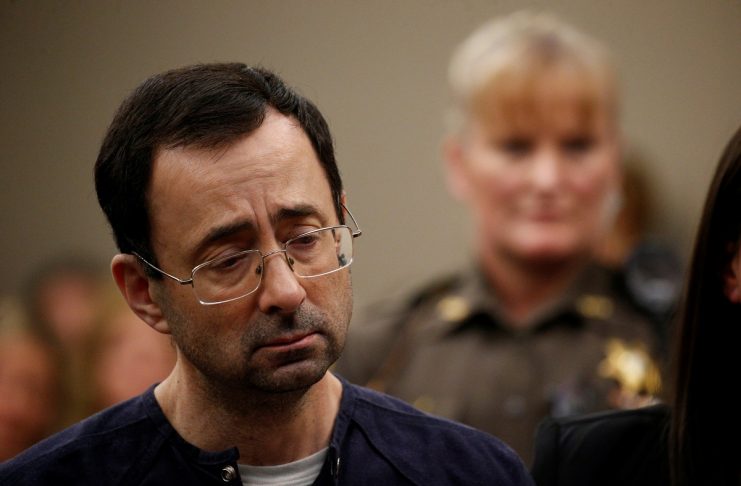 Larry Nassar, a former team USA Gymnastics doctor who pleaded guilty in November 2017 to sexual assault charges, stands during his sentencing hearing in Lansing