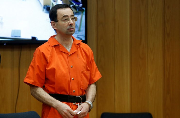Larry Nassar, a former team USA Gymnastics doctor who pleaded guilty in November 2017 to sexual assault charges, stands in court during his sentencing hearing in the Eaton County Court in Charlotte