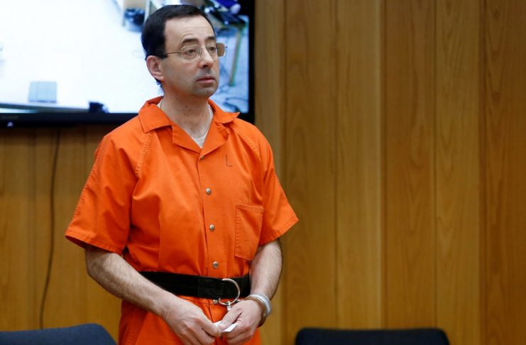Larry Nassar, a former team USA Gymnastics doctor who pleaded guilty in November 2017 to sexual assault charges, stands in court during his sentencing hearing in the Eaton County Court in Charlotte
