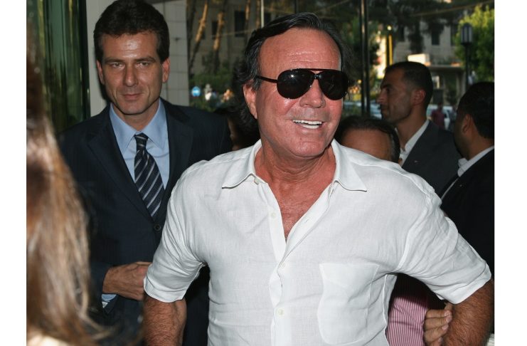 Spanish singer Julio Iglesias arrives for a news conference at a hotel in Damascus