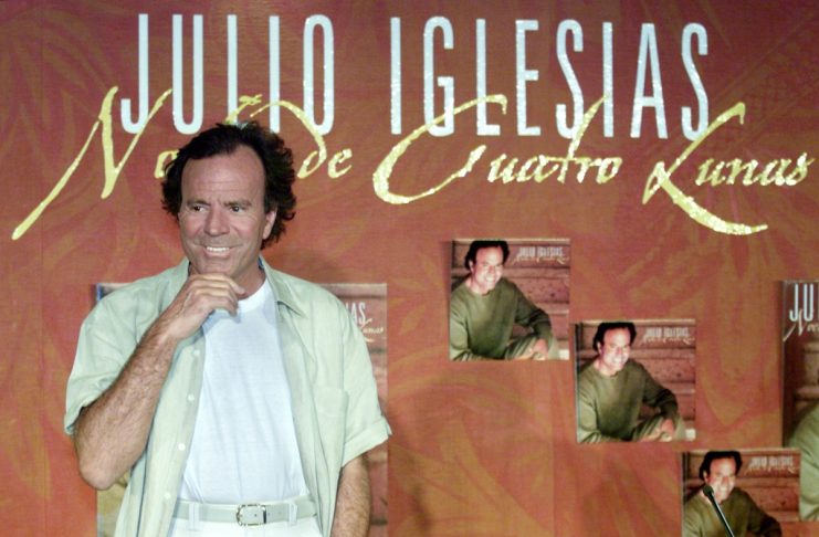 Famous Spanish singer Julio Iglesias gestures as he poses for photographers during the presentation ..