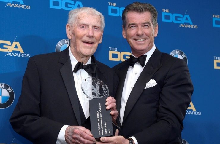 Director Butler accepts the Lifetime Achievement Awards in Television Direction from actor Brosnan at the 67th annual DGA Awards in Los Angeles