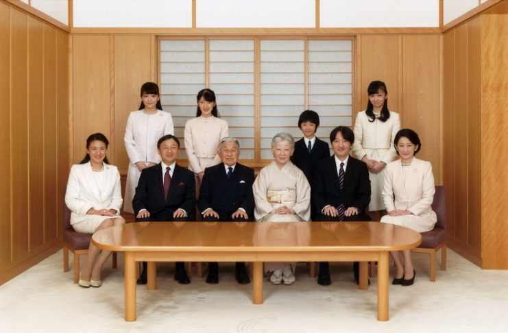 Japanese Emperor Akihito and Empress Michiko smile with their family members during a photo session for the New Year at the Imperial Palace in Tokyo