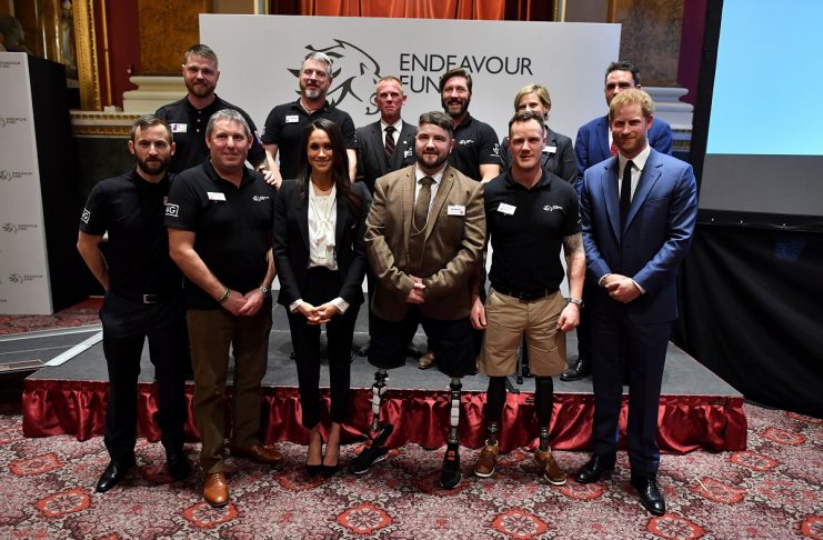 Britain’s Prince Harry and his fiancee Meghan Markle pose for a photo with award winners and award nominees during the annual Endeavour Fund Awards at Goldsmiths’ Hall in London