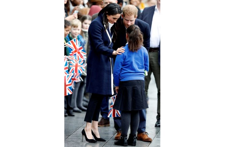 Britain’s Prince Harry and his fiancee Meghan Markle meet local school children during a walkabout on a visit to Birmingham