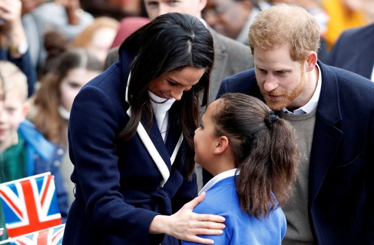 Britain’s Prince Harry and his fiancee Meghan Markle meet local school children during a wakabout on a visit to Birmingham