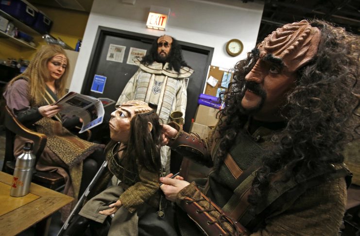 Performer Josh Zagoren plays with a puppet used to represent “Tiny Tim” backstage before a performance of “A Klingon Christmas Carol” in Chicago