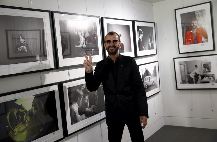 Musician Starr poses in front of some of his photographs during a media event as he launches his book “Photograph” at the National Portrait Gallery in London