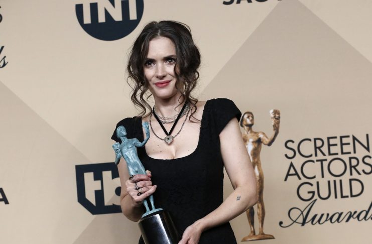 Actress Winona Ryder poses with the award she won for Outstanding Performance by an Ensemble in a Drama Series for her role in “Stranger Things” backstage at the 23rd Screen Actors Guild Awards in Los Angeles