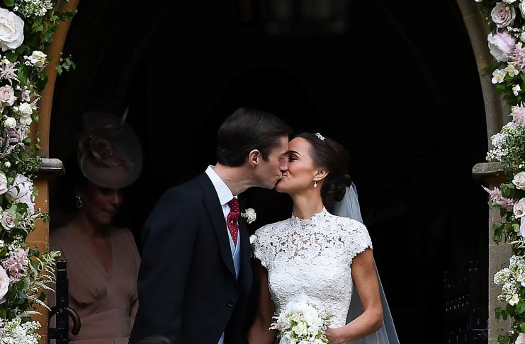 Pippa Middleton kisses her new husband James Matthews, following their wedding ceremony at St Mark’s Church in Englefield