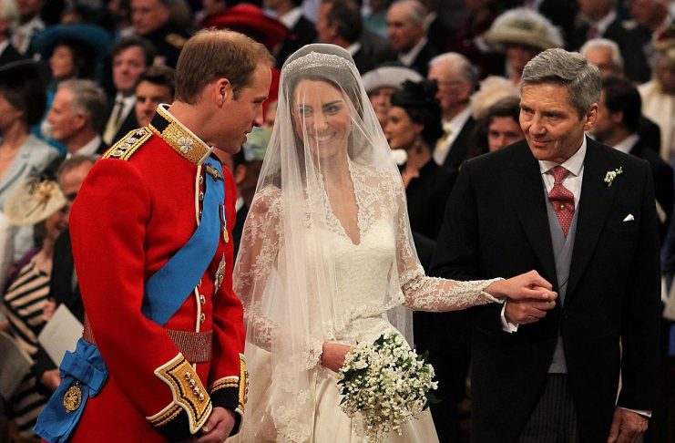 Britain’s Prince William stands at the altar with his bride, Kate Middleton, and her father Michael, during their wedding at Westminster Abbey in central London