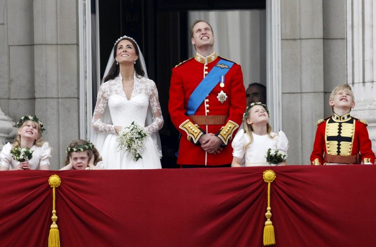 Britain’s Prince William and his wife Catherine, Duchess of Cambridge, watch the fly past as they stand on the balcony at Buckingham Palace after their wedding in Westminster Abbey, in central London