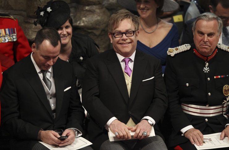 British singer Elton John and his partner David Furnish attend the wedding ceremony of Britain’s Prince William and Kate Middleton at Westminster Abbey in London