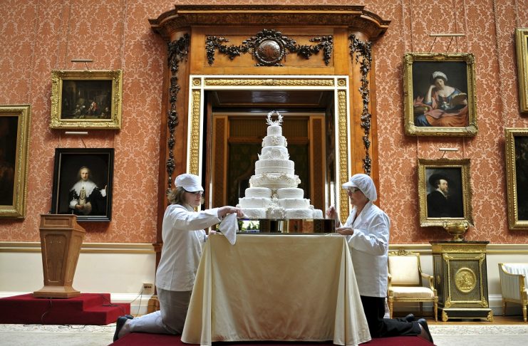 Fiona Cairns’ team, put the finishing touches to Prince William and his wife Catherine, the Duchess of Cambridge’s eight tiered wedding cake, in the Picture Gallery inside Buckingham Palace in London