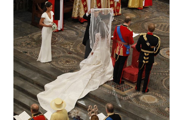 Michael Middleton, lifts the veil off of his daughter Kate, as she stands next to her future husband, Britain’s Prince William, during their wedding ceremony In Westminster Abbey, in central London