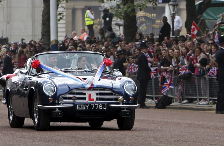 Britain’s Prince William and his wife Catherine, Duchess of Cambridge drive from Buckingham Palace in an Aston Martin DB6 Mark 2, after their wedding in Westminster Abbey, in central London
