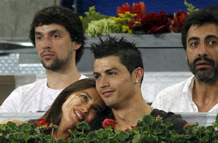 Real Madrid’s Cristiano Ronaldo reacts as his girlfriend Shayk rests on his shoulder during their Madrid Open men’s quarter-final match between Roger Federer of Switzerland and David Ferrer of Spain in Madrid