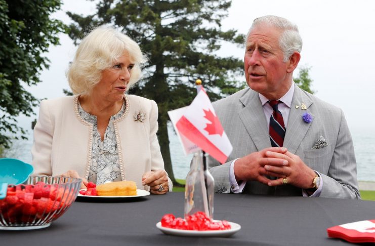 Britain’s Prince Charles and Camilla, Duchess of Cornwall, talk with locals while touring the farmers’ market in Wellington