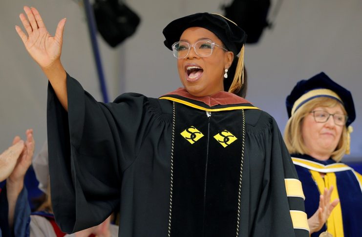 Entertainer Oprah Winfrey waves to the crowd after receiving an honorary Doctor of Fine Arts degree during Commencement ceremonies at Smith College in Northampton