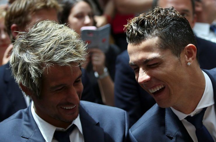 Real Madrid’s Cristiano Ronaldo and teammate Coentrao attend a ceremony after winning La Liga title at the headquarters of Madrid’s regional government in Madrid