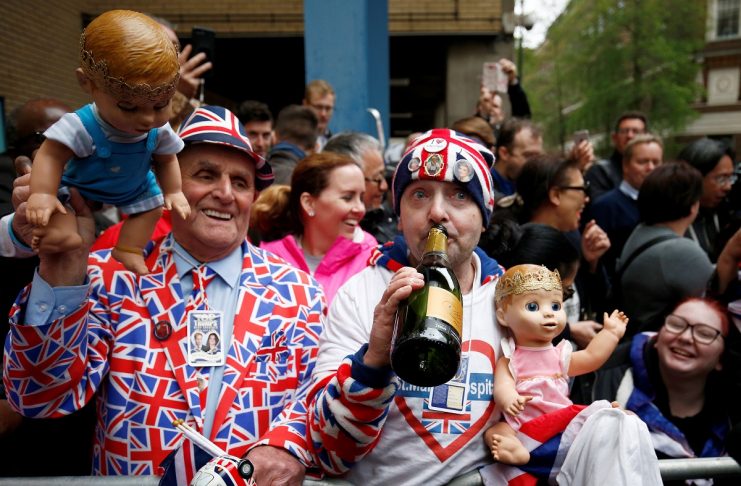 Two supporters of the royal family holding dolls wearing crowns celebrate outside the Lindo Wing of St Mary’s Hospital after Britain’s Catherine, the Duchess of Cambridge, gave birth to a son, in London
