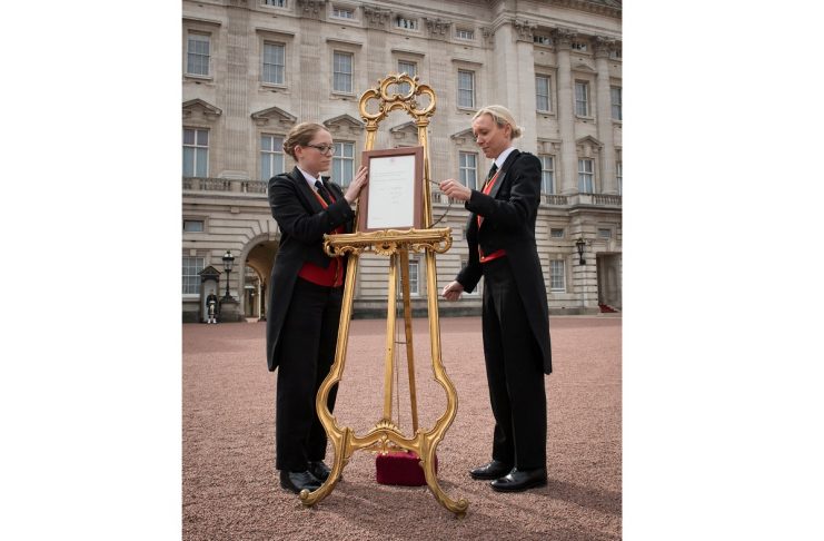 Senior footman Olivia Smith and footman Heather McDonald place a notice on an easel in the forecourt of Buckingham Palace to formally announce the birth of a baby boy to the Britain’s Catherine, the Duchess of Cambridge, and Prince William, in London