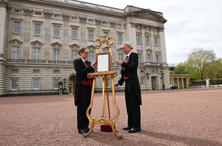Senior footman Olivia Smith and footman Heather McDonald place a notice on an easel in the forecourt of Buckingham Palace to formally announce the birth of a baby boy to the Britain’s Catherine, the Duchess of Cambridge, and Prince William, in London