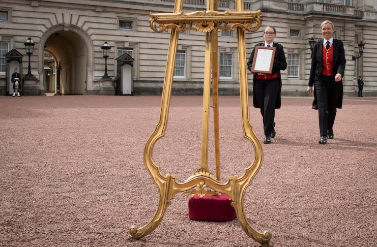 Senior footman Olivia Smith and footman Heather McDonald arrive place a notice on an easel in the forecourt of Buckingham Palace to formally announce the birth of a baby boy to the Britain’s Catherine, the Duchess of Cambridge, and Prince William, London