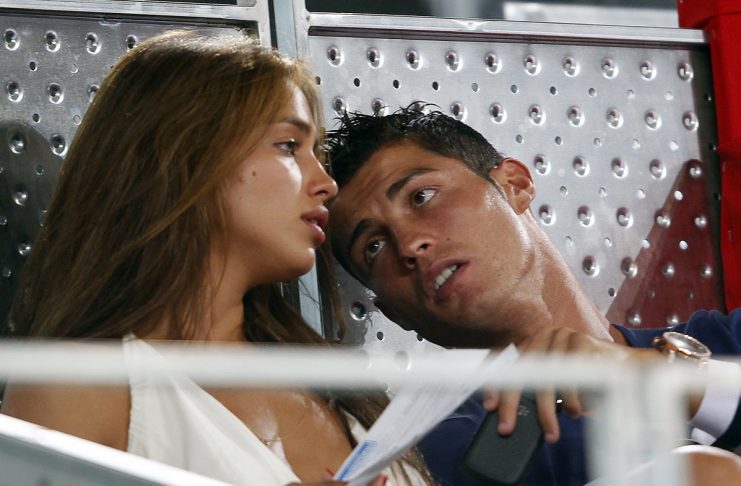 Real Madrid’s Cristiano Ronaldo talks with Irina Shayk as they attend a friendly basketball game in Madrid