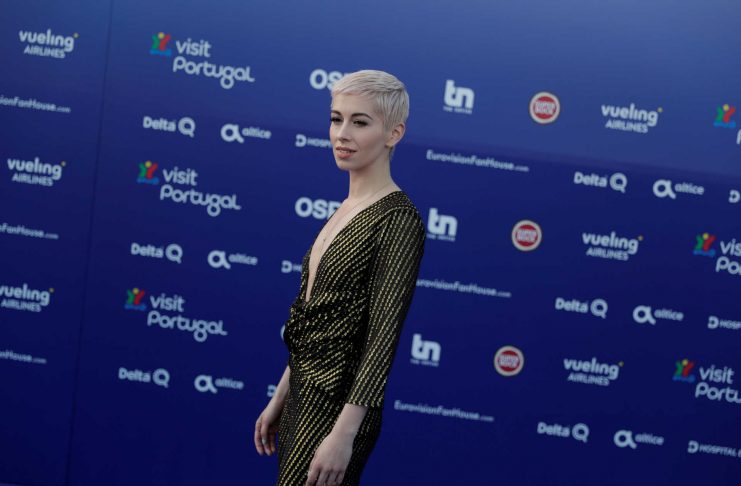Contestant SuRie of United Kingdom poses on the blue carpet during the opening party for Eurovision Song Contest at the Maat museum in Lisbon