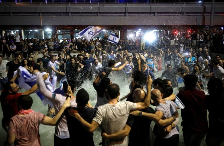Israeli fans celebrate at Rabin square in Tel Aviv Israel, after Israeli singer Netta Barzilai won the Grand Final of Eurovision Song Contest 2018