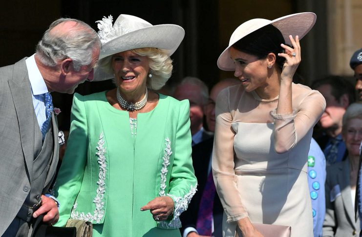 Meghan, Duchess of Sussex attends a garden party at Buckingham Palace, with Camilla the Duchess of Cornwall and Prince Charles, in London