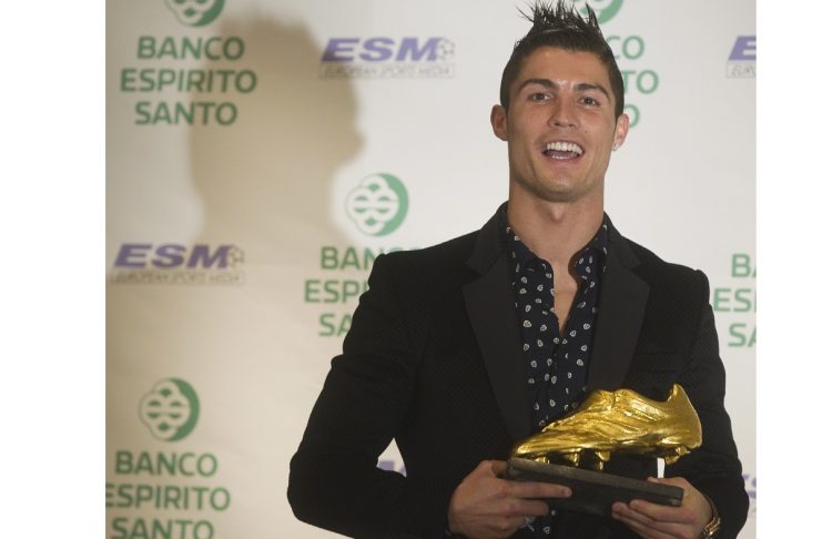 Real Madrid’s soccer star Portuguese Cristiano Ronaldo smiles as he poses with the European Golden Shoe trophy after receiving it in a ceremony in Madrid