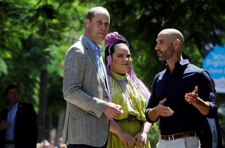 Britain’s Prince William stands with Israeli 2018 Eurovision song contest winner Netta Barzilai and a tour guide during a tour of Rothschild Boulevard, in Tel Aviv, Israel