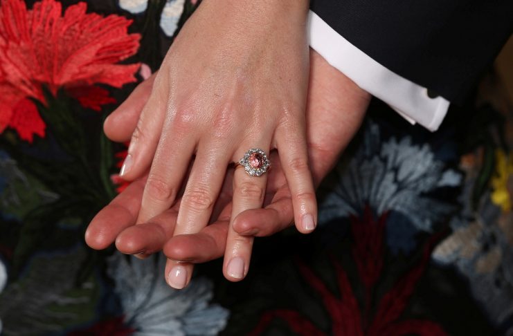 Britain’sPrincess Eugenie wears a ring containing a padparadscha sapphire surrounded by diamonds as she and Jack Brooksbank pose in the Picture Gallery after they announced their engagement, at Buckingham Palace, London