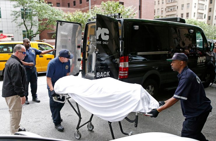 Medical examiners remove the body from the Park Avenue apartment of designer Kate Spade in New York