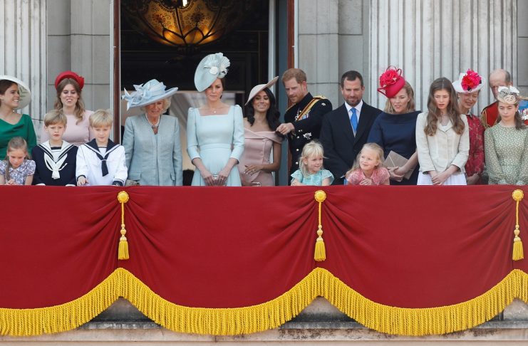 Britain’s Prince Harry and Meghan, Duchess of Sussex, along with other members of the British royal family, look down into the palace courtyard from the balcony of Buckingham Palace as part of Trooping the Colour parade in central London