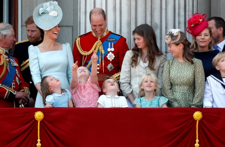 Younger members of Britain’s royal family, along with Prince William and Catherine, Duchess of Cambridge, look up at the RAF flypast from the balcony of Buckingham Palace as part of Trooping the Colour parade in central London