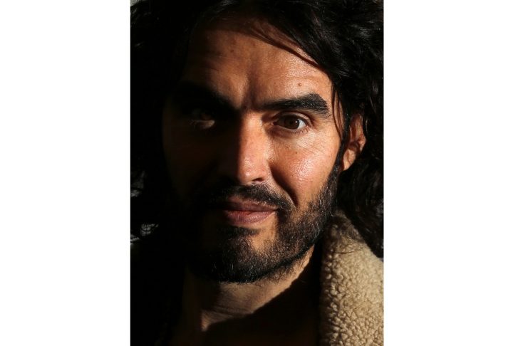 Russell Brand poses for photographers before signing copies of new book entitled “Revolution” in central London