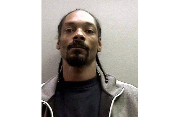 Booking photo of rapper Snoop Dogg surrendered to authorities after an arrest warrant was issued, charging him with possession of a deadly weapon stemming from an incident at Orange County John Wayne Airport. Photo taken November 6, 2006. 


REUTERS/Orange