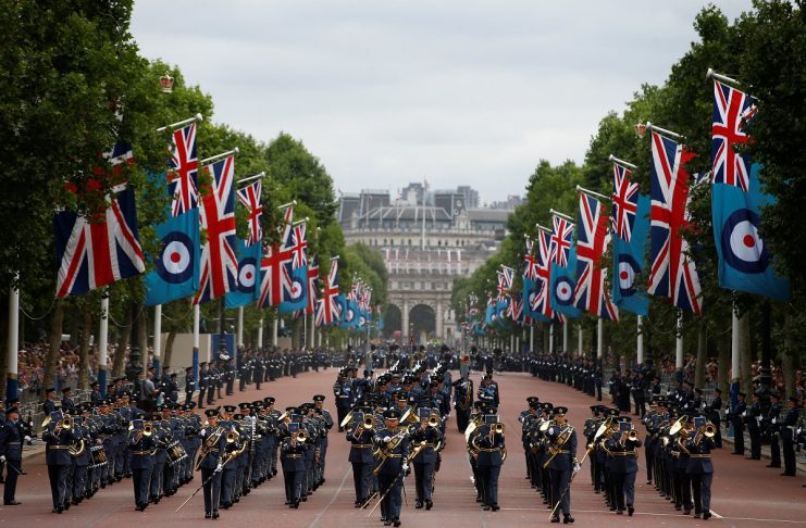 A military band marches along the Mall ahead of a flypast to mark the centenary of the Royal Air Force, in central London
