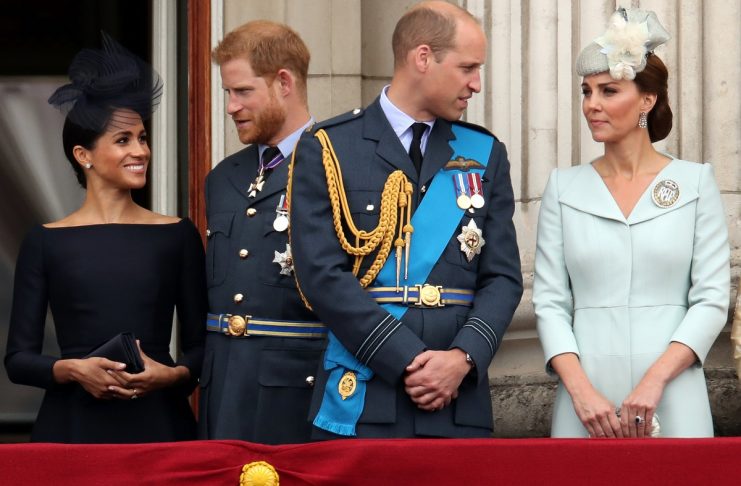 Britain’s Meghan, Duchess of Sussex, Prince Harry, Prince William, Catherine, Duchess of Cambridge  stand on the balcony of Buckingham Palace as they watch a fly past to mark the centenary of the Royal Air Force in central London